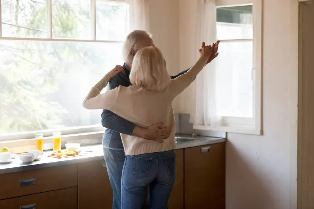 witharig paar dansend in keuken